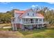 Charming home with a lovely porch and ample lawn space, perfect for outdoor activities at 1214 Tabby Dr, Folly Beach, SC 29439
