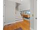 Light-filled foyer with hardwood floors leading into open living space with stairs at 1214 Tabby Dr, Folly Beach, SC 29439