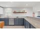 Spacious kitchen with stainless steel appliances and a decorative wall shelf at 1214 Tabby Dr, Folly Beach, SC 29439