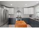 Bright kitchen featuring stainless steel appliances, butcher block island, and custom cabinetry at 1214 Tabby Dr, Folly Beach, SC 29439