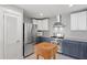 Bright kitchen featuring stainless steel appliances, butcher block island, and custom cabinetry at 1214 Tabby Dr, Folly Beach, SC 29439