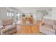 Open living and dining area with hardwood floors and access to outdoor spaces at 1214 Tabby Dr, Folly Beach, SC 29439