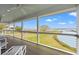 Covered porch featuring an outdoor ceiling fan and expansive views of marsh, river, and waterfront at 1214 Tabby Dr, Folly Beach, SC 29439