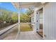 Enjoy this outdoor porch space with wooden floors and railings overlooking the lush landscaping at 1214 Tabby Dr, Folly Beach, SC 29439