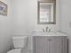 Elegant powder room featuring modern fixtures, a marble countertop, and a framed mirror at 1214 Tabby Dr, Folly Beach, SC 29439