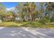 Street view of a lot with mature trees and potential home site visible from the road at 1214 Tabby Dr, Folly Beach, SC 29439