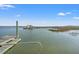 A scenic view of a pier extending into the water, under a clear blue sky at 1214 Tabby Dr, Folly Beach, SC 29439