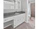 Well-lit bathroom featuring a vanity with gray countertop, a large mirror, and a tiled shower at 103 Sycamore Dr, Summerville, SC 29485