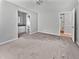 Spacious bedroom with neutral carpet, gray walls and a bathroom, with a hallway entrance at 103 Sycamore Dr, Summerville, SC 29485