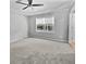This is a well-lit bedroom with a ceiling fan and plush gray carpeting at 103 Sycamore Dr, Summerville, SC 29485