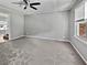 This is a well-lit bedroom with a ceiling fan and plush gray carpeting at 103 Sycamore Dr, Summerville, SC 29485