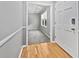 View from the front door to a hallway with hardwood flooring and a view of a room with natural light at 103 Sycamore Dr, Summerville, SC 29485