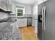 Modern kitchen features stainless steel appliances, granite countertops, and white cabinetry at 103 Sycamore Dr, Summerville, SC 29485