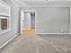 Living room featuring neutral carpet, grey walls, and view to hallway and window with natural light at 103 Sycamore Dr, Summerville, SC 29485