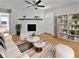 Bright living room with hardwood floors, fireplace, stylish furniture, and a decorative ceiling fan at 103 Sycamore Dr, Summerville, SC 29485