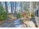 Serene backyard featuring a stone walkway, lush greenery, a wooden fence, and mature trees at 106 Sago Palm Ct, Summerville, SC 29483