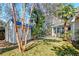 Backyard with a storage shed, mature trees, and lush vegetation, offering a private outdoor space at 106 Sago Palm Ct, Summerville, SC 29483