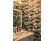 Stylish powder room with patterned wallpaper, modern vanity, and elegant fixtures at 106 Sago Palm Ct, Summerville, SC 29483