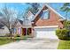 Charming brick home with manicured lawn, American flag, and a two-car garage for curb appeal at 106 Sago Palm Ct, Summerville, SC 29483