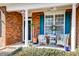 Inviting front porch with comfortable seating, lush greenery, and decorative wreaths, perfect for relaxing outdoors at 106 Sago Palm Ct, Summerville, SC 29483