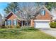 Charming brick home boasts a manicured lawn and a two-car garage at 106 Sago Palm Ct, Summerville, SC 29483