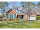 Charming brick home boasts a manicured lawn and a two-car garage at 106 Sago Palm Ct, Summerville, SC 29483