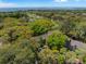 Aerial view showing rooftops, golf course, and ocean view within a lush landscape at 108 High Hammock Villas Dr, Seabrook Island, SC 29455
