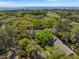 Rooftop aerial view with lush trees and a view of the golf course and ocean beyond at 108 High Hammock Villas Dr, Seabrook Island, SC 29455