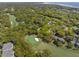 Homes nestled among trees and a golf course can be seen in this aerial shot of the community at 108 High Hammock Villas Dr, Seabrook Island, SC 29455