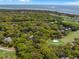 Golf community properties are captured in an aerial view, surrounded by lush, green vegetation at 108 High Hammock Villas Dr, Seabrook Island, SC 29455