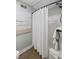 Cozy bathroom featuring a tub with a white shower curtain and coastal-themed art at 108 High Hammock Villas Dr, Seabrook Island, SC 29455