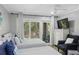Bright bedroom with two twin beds, stylish furnishings, and a sliding glass door to the outdoors at 108 High Hammock Villas Dr, Seabrook Island, SC 29455