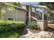 Attractive tan condominium complex with stairs to elevated porch and lush green landscaping at 108 High Hammock Villas Dr, Seabrook Island, SC 29455