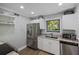 Efficient kitchen with stainless steel appliances, white cabinets, and plenty of natural light at 108 High Hammock Villas Dr, Seabrook Island, SC 29455