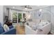 Bright living room featuring neutral furniture, ceiling fan, and sliding glass doors at 108 High Hammock Villas Dr, Seabrook Island, SC 29455
