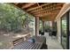 Outdoor patio with a large wooden dining table surrounded by seating and lush greenery at 108 High Hammock Villas Dr, Seabrook Island, SC 29455