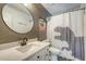 The renovated bathroom features a shower with themed shower curtain, round mirror, and white vanity at 1134 Shadow Lake Cir # 55, Mount Pleasant, SC 29464