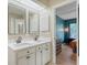 The bathroom features a double vanity with white cabinets and stone counters with view into the bedroom at 1134 Shadow Lake Cir # 55, Mount Pleasant, SC 29464