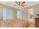 Bedroom featuring hardwood floors, closet doors, a ceiling fan, and access to an ensuite bathroom at 1134 Shadow Lake Cir # 55, Mount Pleasant, SC 29464