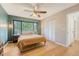 Well-lit bedroom features a ceiling fan, wooden floors, and a large window with view of the outdoors at 1134 Shadow Lake Cir # 55, Mount Pleasant, SC 29464
