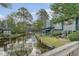 Charming waterfront home with mature trees and lush landscaping along the tranquil lagoon at 1134 Shadow Lake Cir # 55, Mount Pleasant, SC 29464