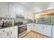 Bright kitchen features white cabinets, granite countertops, and stainless steel appliances at 1134 Shadow Lake Cir # 55, Mount Pleasant, SC 29464