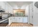 Well-maintained kitchen with black appliances, white cabinets, and black and white backsplash at 1134 Shadow Lake Cir # 55, Mount Pleasant, SC 29464