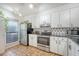 Kitchen featuring white cabinets, stainless steel appliances, and neutral backsplash at 1134 Shadow Lake Cir # 55, Mount Pleasant, SC 29464