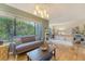 Bright and spacious living room with hardwood floors, a cozy seating area, and a seamless flow into the dining space at 1134 Shadow Lake Cir # 55, Mount Pleasant, SC 29464