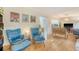 Bright living room featuring hardwood floors, blue accent chairs, and views into the kitchen at 1134 Shadow Lake Cir # 55, Mount Pleasant, SC 29464