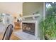 Cozy living room boasts a fireplace, hardwood floors, plants, and views from a large window at 1134 Shadow Lake Cir # 55, Mount Pleasant, SC 29464