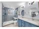 Modern bathroom with double vanity, grey tile shower and glass surround at 118 Congress St # F, Charleston, SC 29403