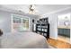 Bedroom boasts a view to the ensuite bathroom, a ceiling fan and a large black bookcase at 118 Congress St # F, Charleston, SC 29403