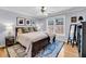 Bright bedroom featuring a ceiling fan, hardwood floors, and a large window with natural light at 118 Congress St # F, Charleston, SC 29403